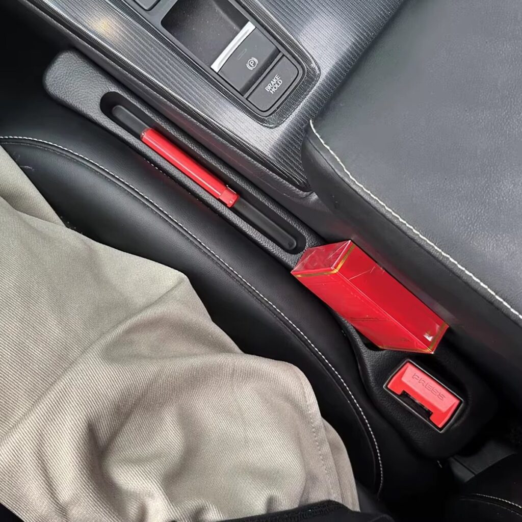 Gap filler holding a small item next to the seat